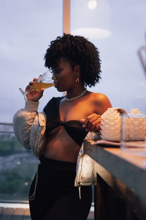 A Sexy Woman in Black Top Drinking Wine