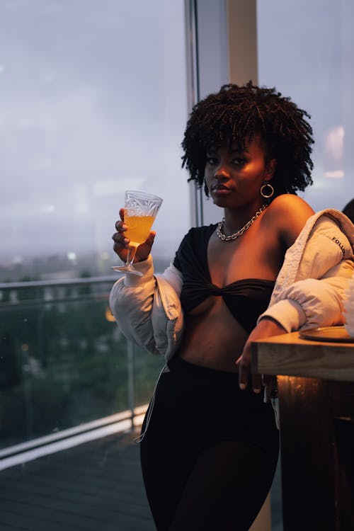 A Sexy Woman in Black Top Holding a Drink