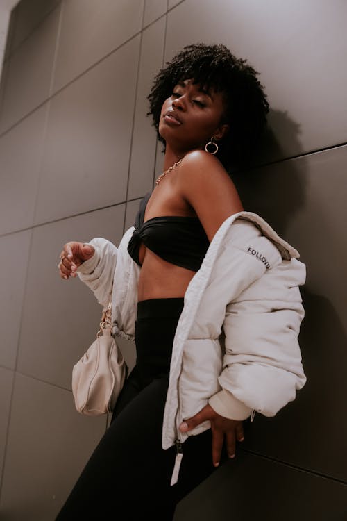 Portrait of a Woman Standing Next to a Wall