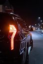 A Black Car on the Road at Night