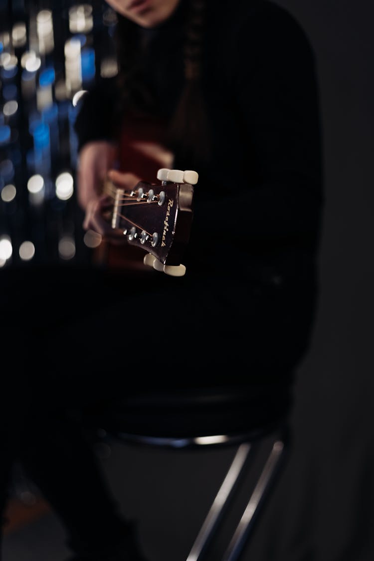 Close Up Of Woman Playing Guitar