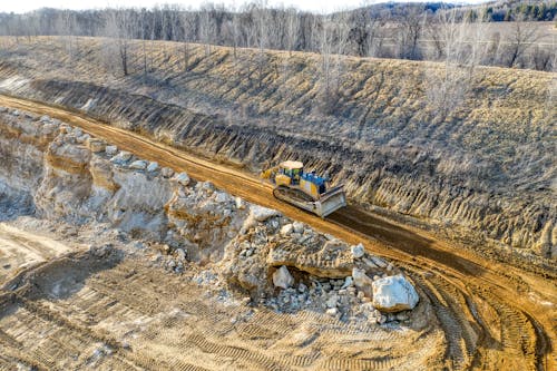 Yellow Bulldozer Working on Coal Mine