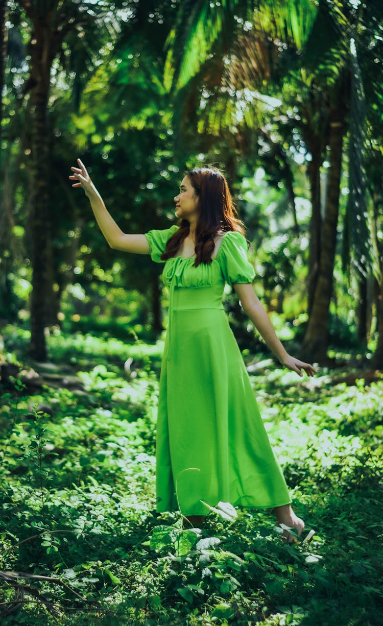 Woman In Green Dress Among Trees