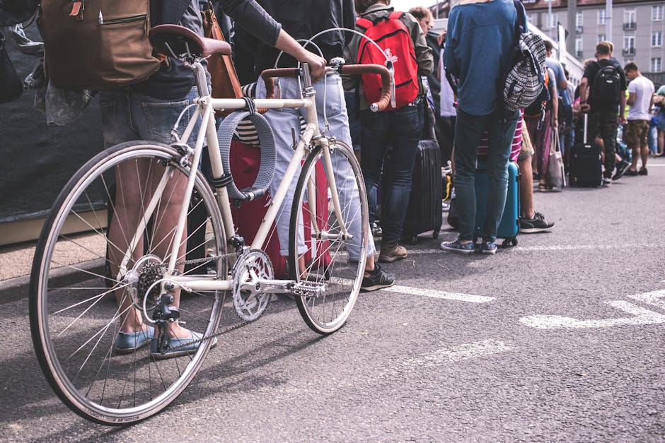 Person in Black Sweater Hold a Grey Road Bike