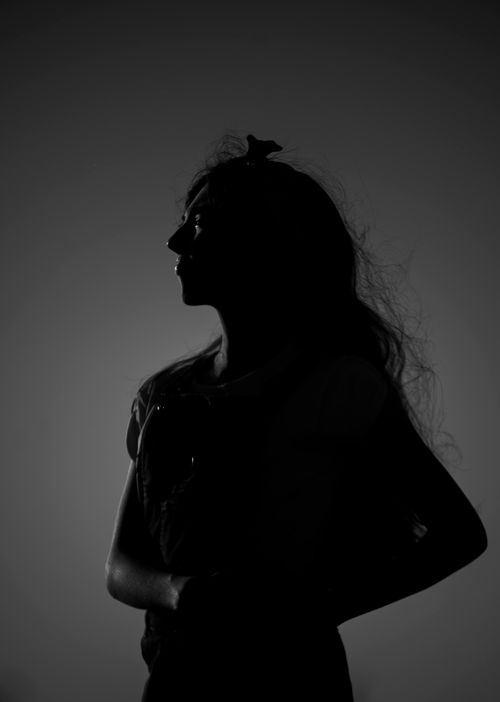 Free Black and white silhouette of a woman with flowing hair, captured in profile. Stock Photo