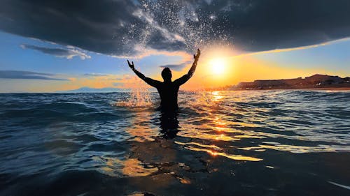 Free Silhouette of Person in Water during Sunset Stock Photo