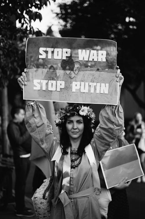 Woman Holding Stop War Poster
