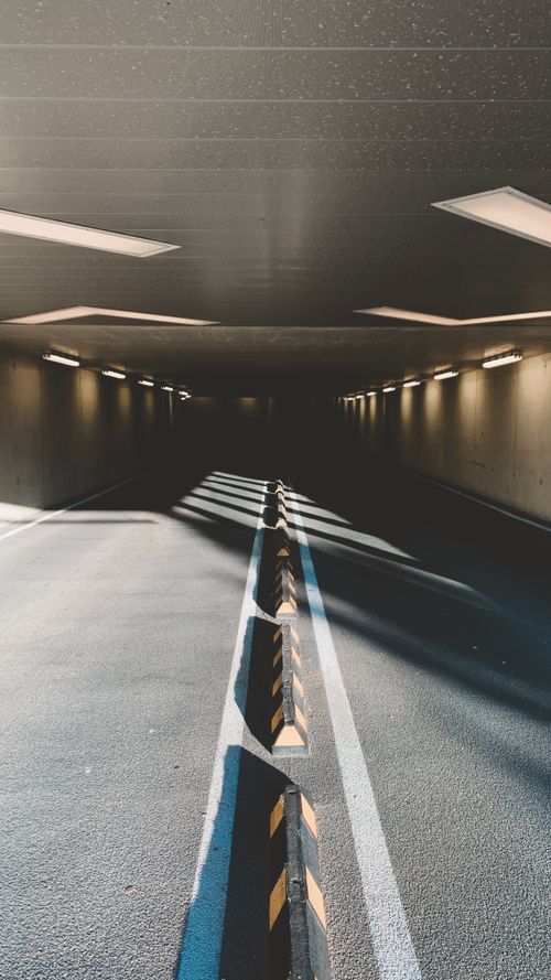 Free An empty tunnel in Alkmaar, Netherlands, emphasizing light and shadow contrasts. Stock Photo