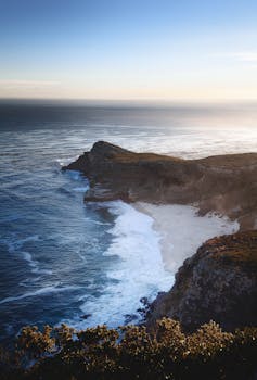 Breathtaking aerial view of Cape Point's pristine coastline at sunrise in Cape Town, South Africa.