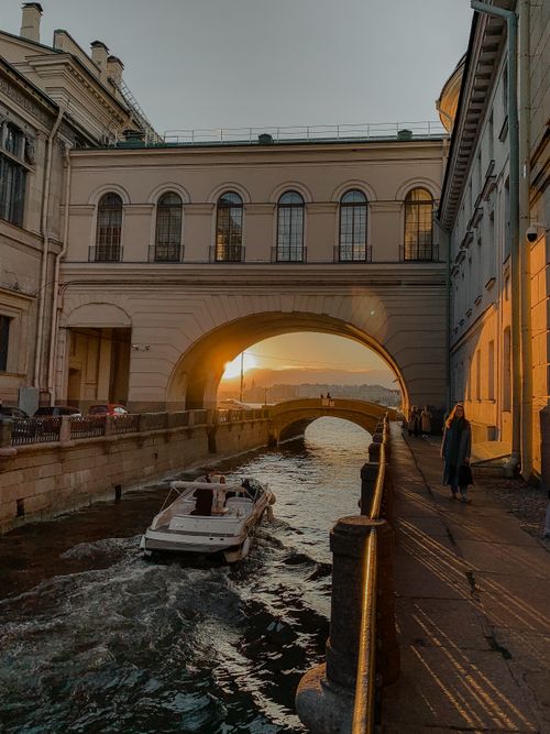 Free Serene sunset scene at Winter Canal with motorboat in Saint Petersburg, Russia. Stock Photo