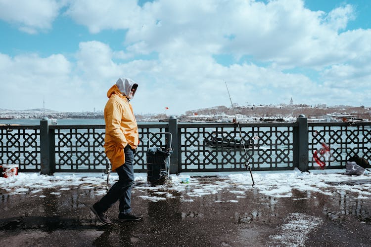 Man Walking On Galata Bridge In Winter