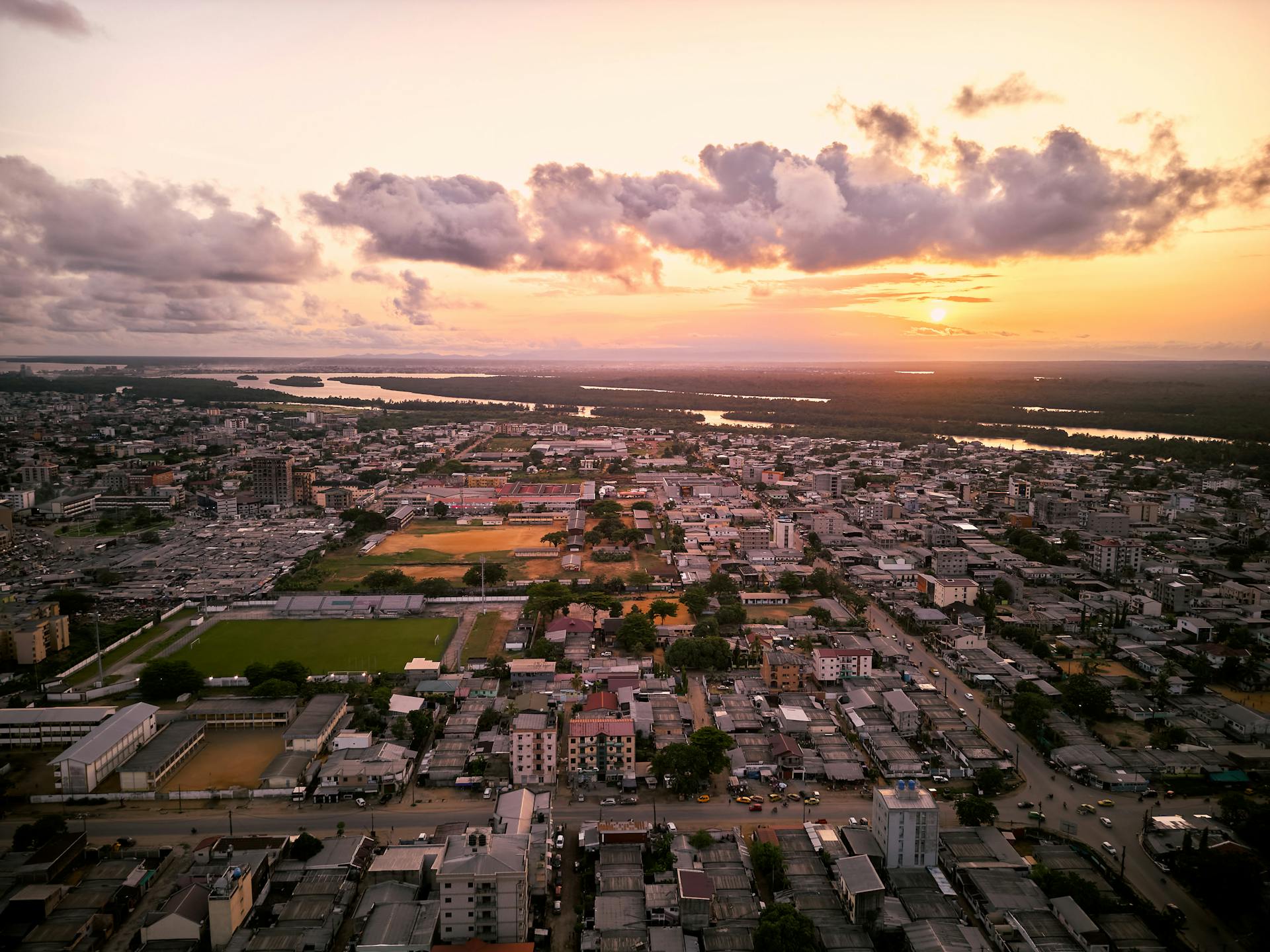 Breathtaking aerial shot of Douala, Cameroon showcasing cityscape and vibrant sunset.