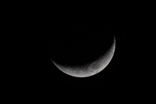 Free A stunning crescent moon against a dark night sky, showcasing lunar details. Stock Photo