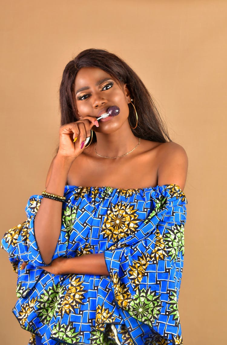 A Beautiful Woman In Off Shoulder Top Biting A Stick With Lollipop