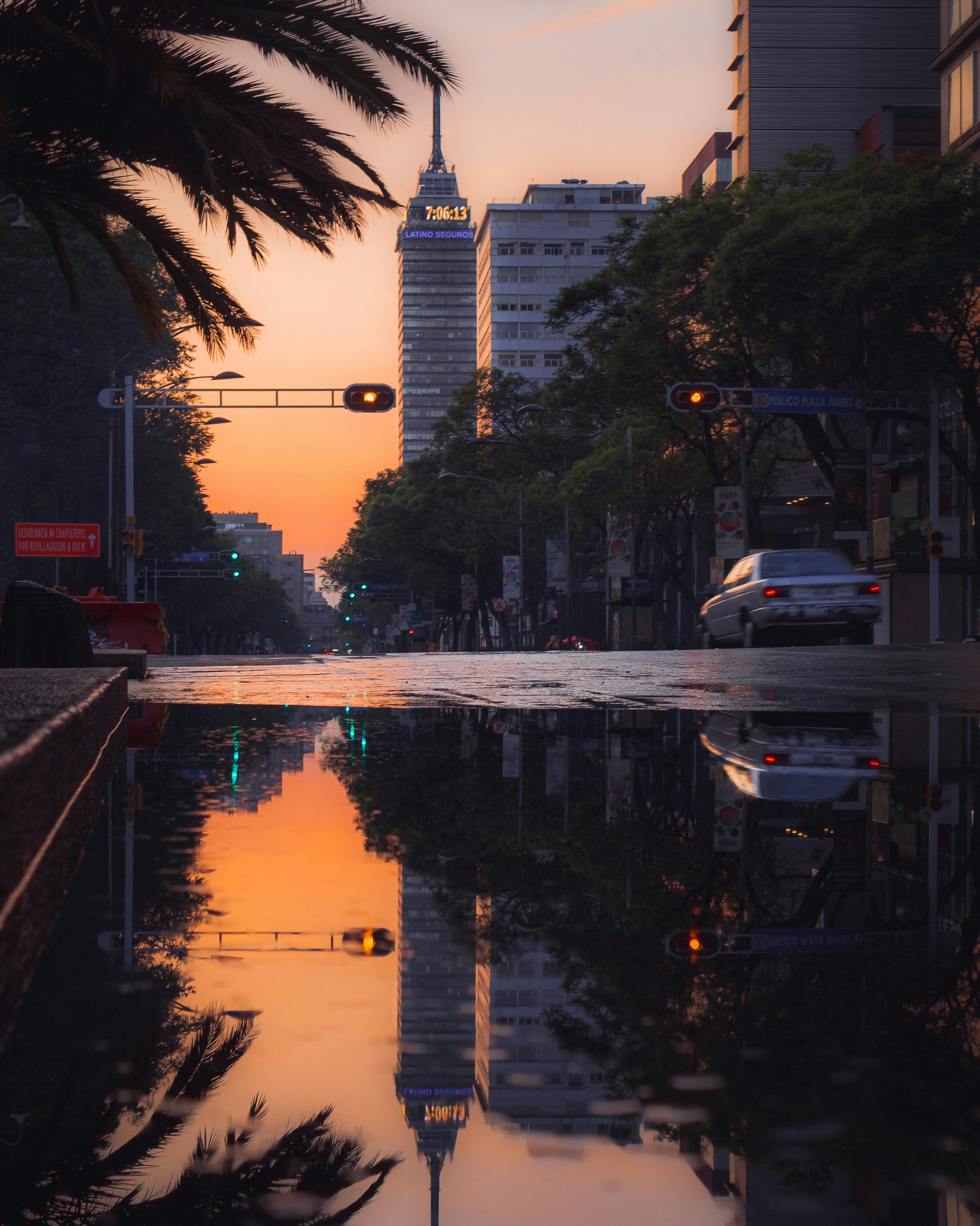 A stunning sunset reflected in puddles on a Mexico City street with the Torre Latinoamericana.
