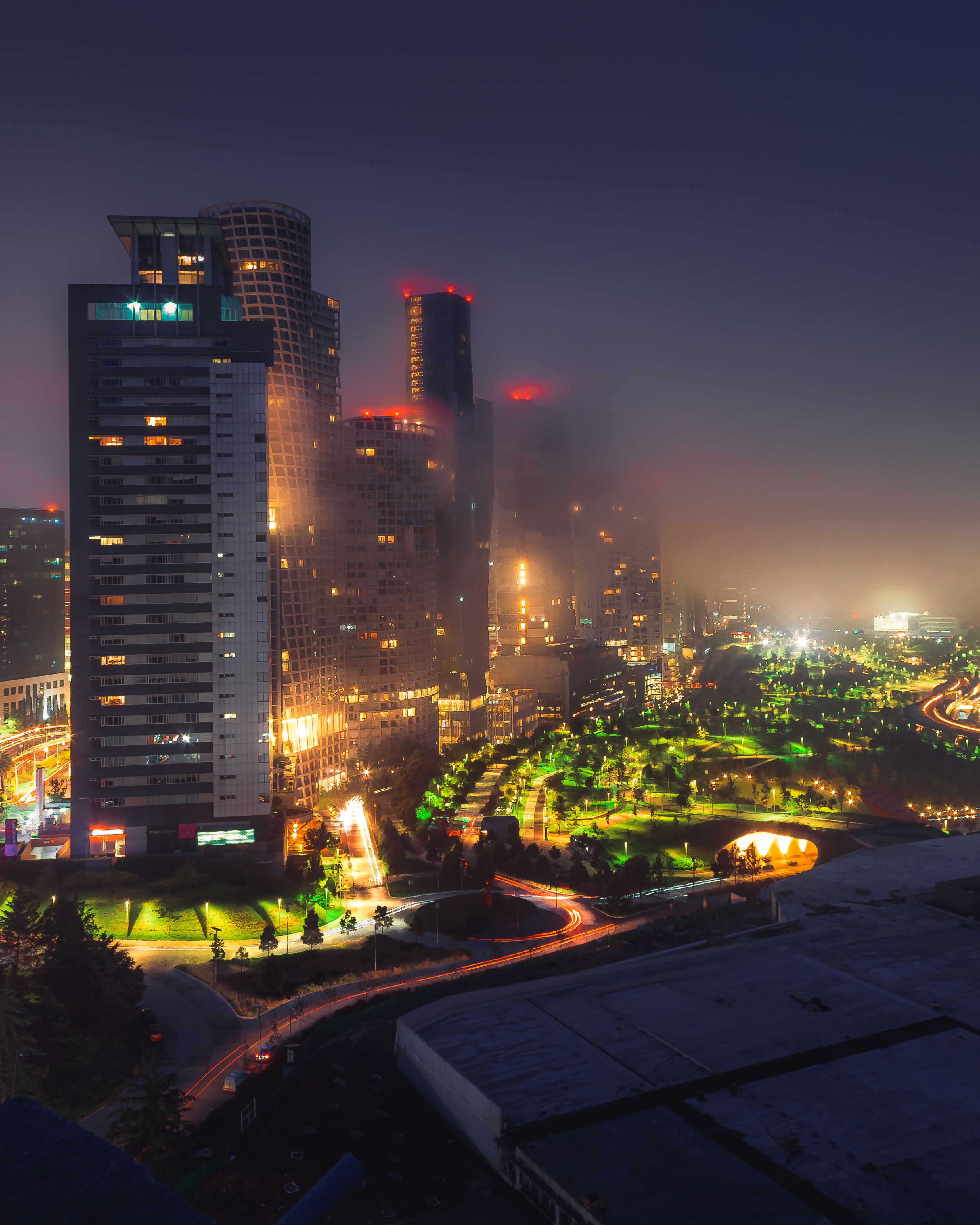 Stunning view of illuminated skyscrapers and city lights in Ciudad de México at night.