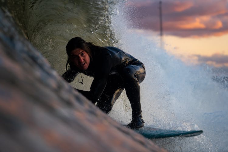 Man Surfing On Wave