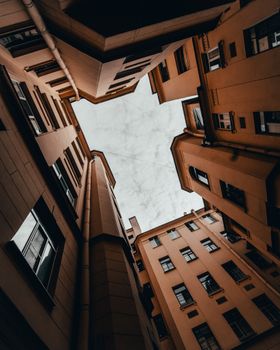 Low-angle shot of urban buildings creating a geometric view of the sky.