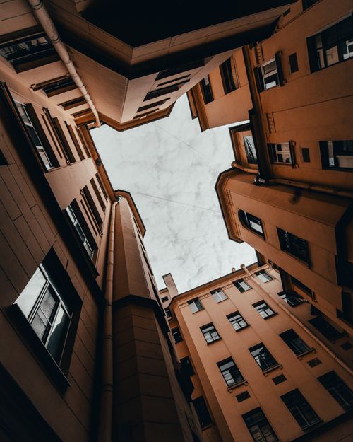Free Low-angle shot of urban buildings creating a geometric view of the sky. Stock Photo