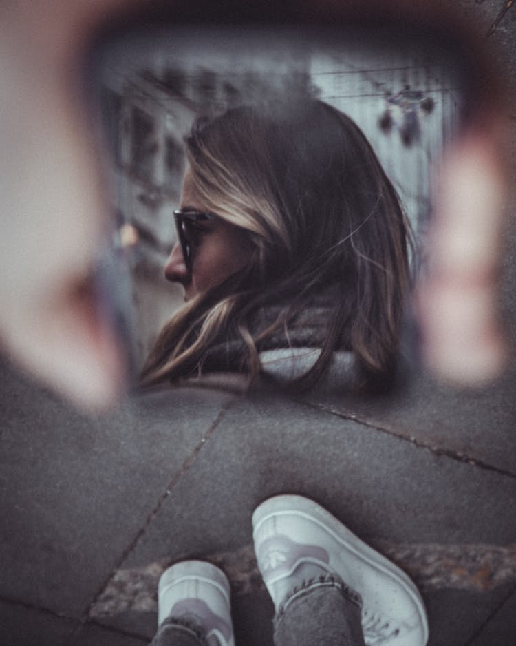 Reflection Of A Woman In A Mirror