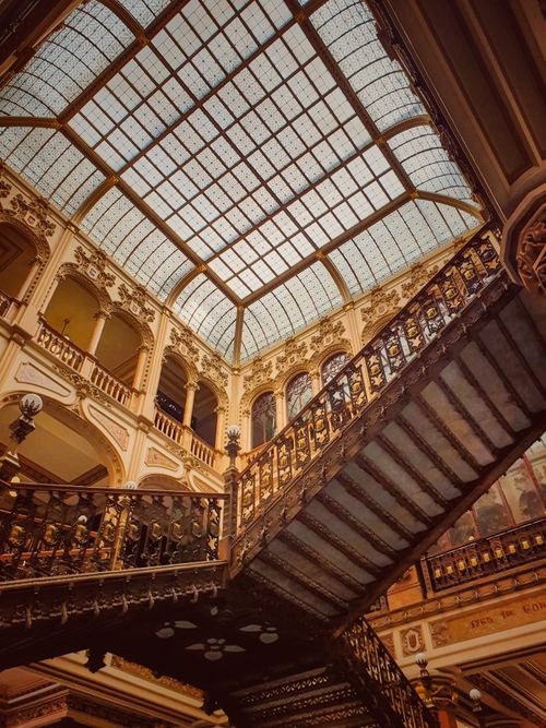 Free Majestic staircase in a historic building atrium with a glass ceiling. Stock Photo