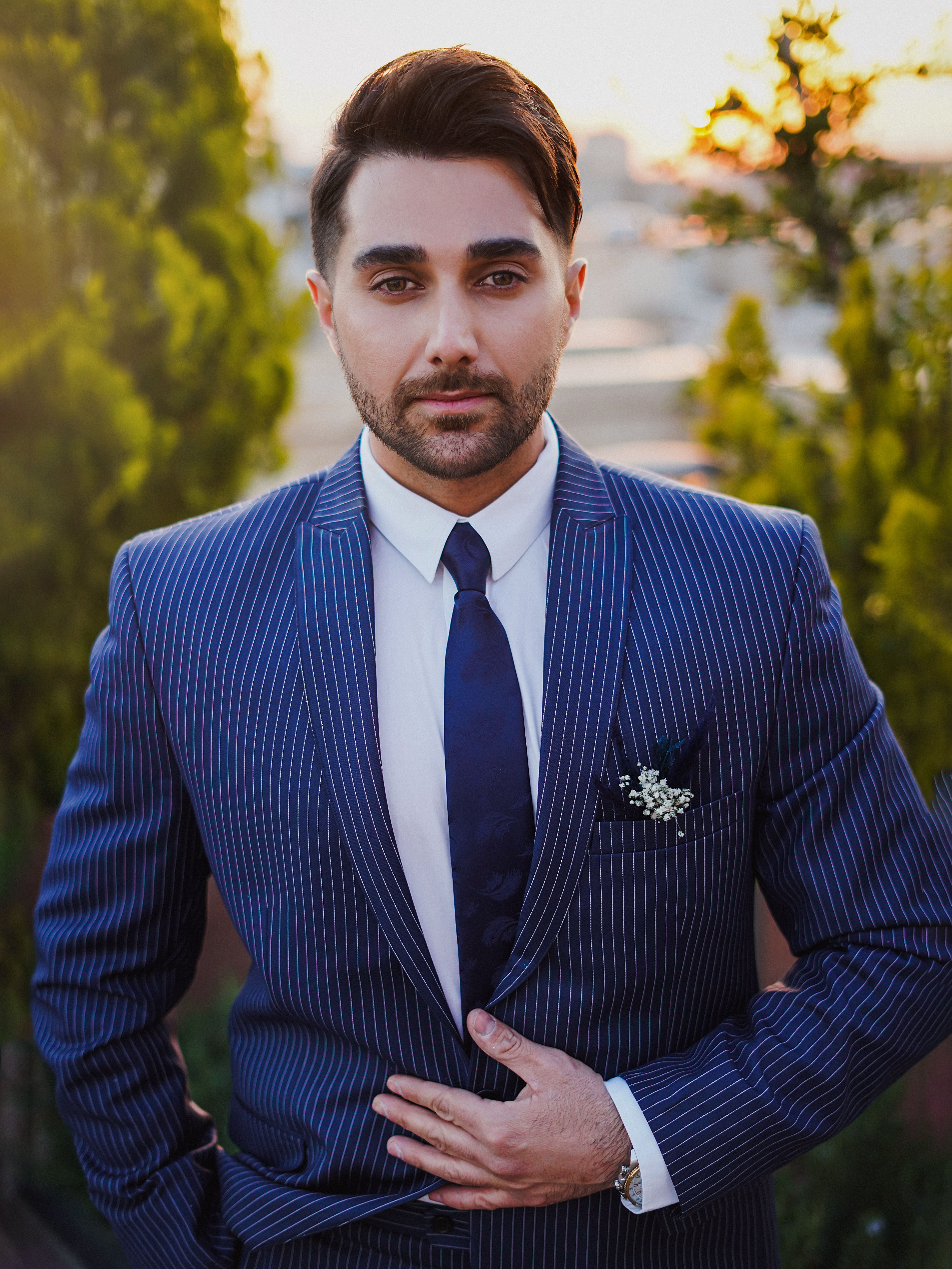Elegant portrait of a man in a pinstripe suit, outdoors in Arak, Iran.