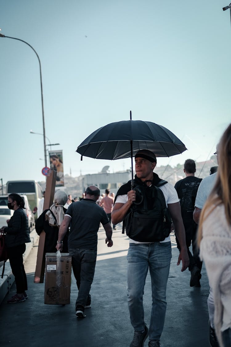 Man With Umbrella Among People