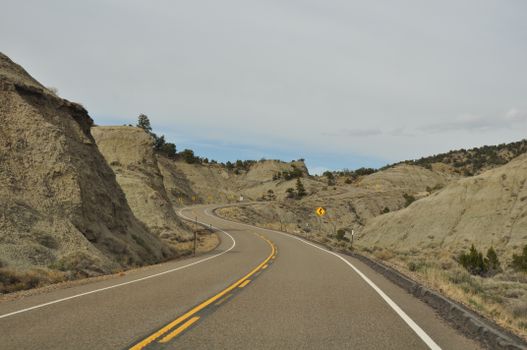 A winding highway through the Arizona desert landscape, showcasing arid scenery and curves.