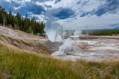 Free Breathtaking view of a steaming geyser in Yellowstone National Park, USA, surrounded by nature. Stock Photo