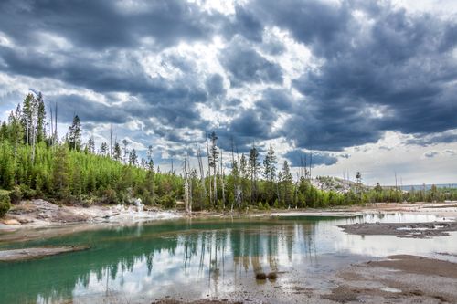 Free Dramatic sky over a tranquil lake in Yellowstone, showcasing nature's beauty and wilderness. Stock Photo