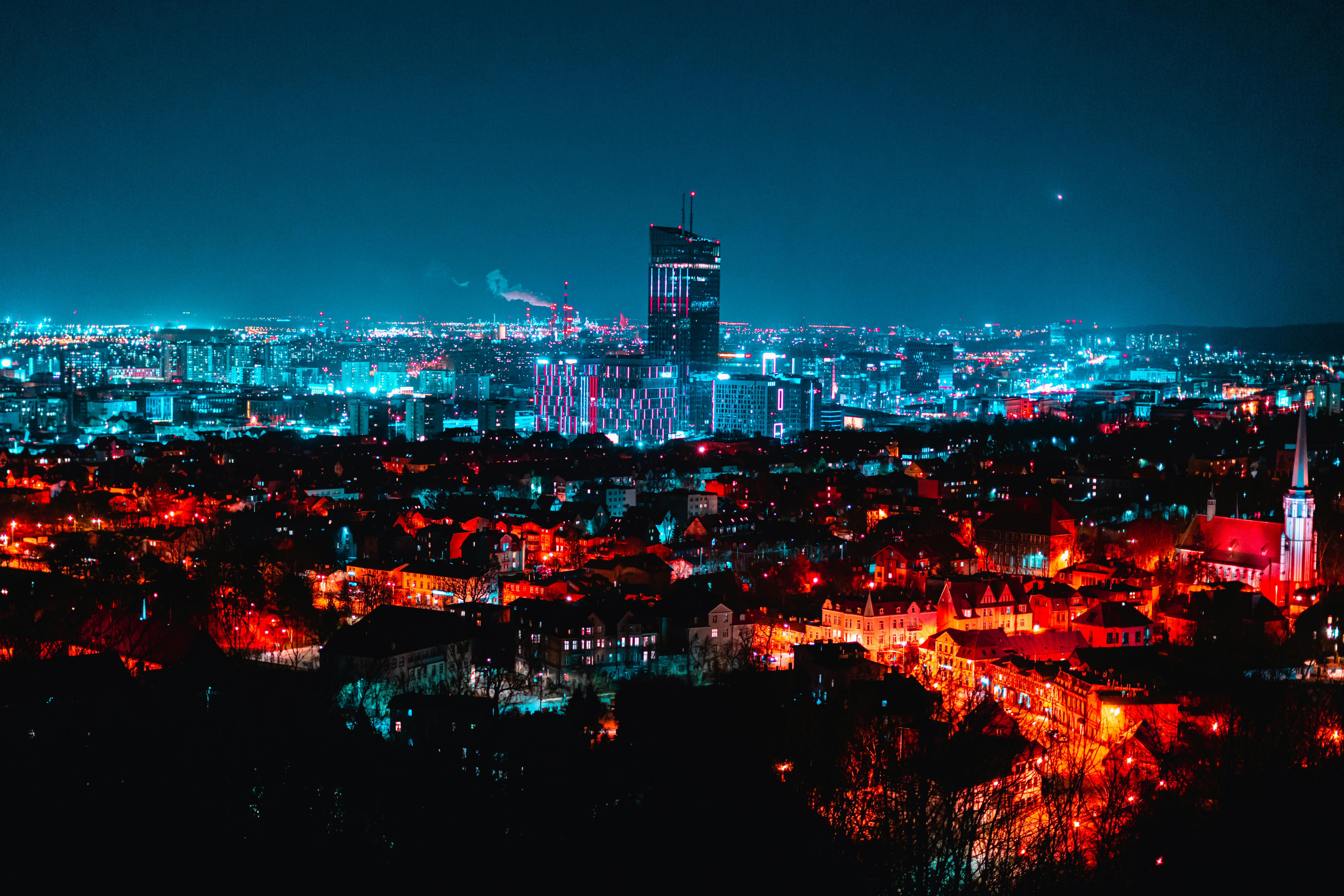 Stunning aerial view of a cityscape at night, featuring bright lights and a glowing skyline.