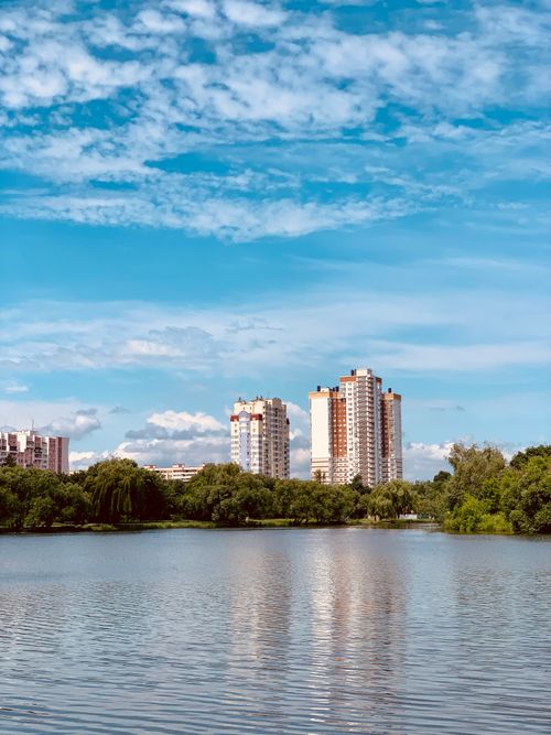 Free Scenic view of residential high-rise buildings reflecting on a lake in Minsk, Belarus. Stock Photo
