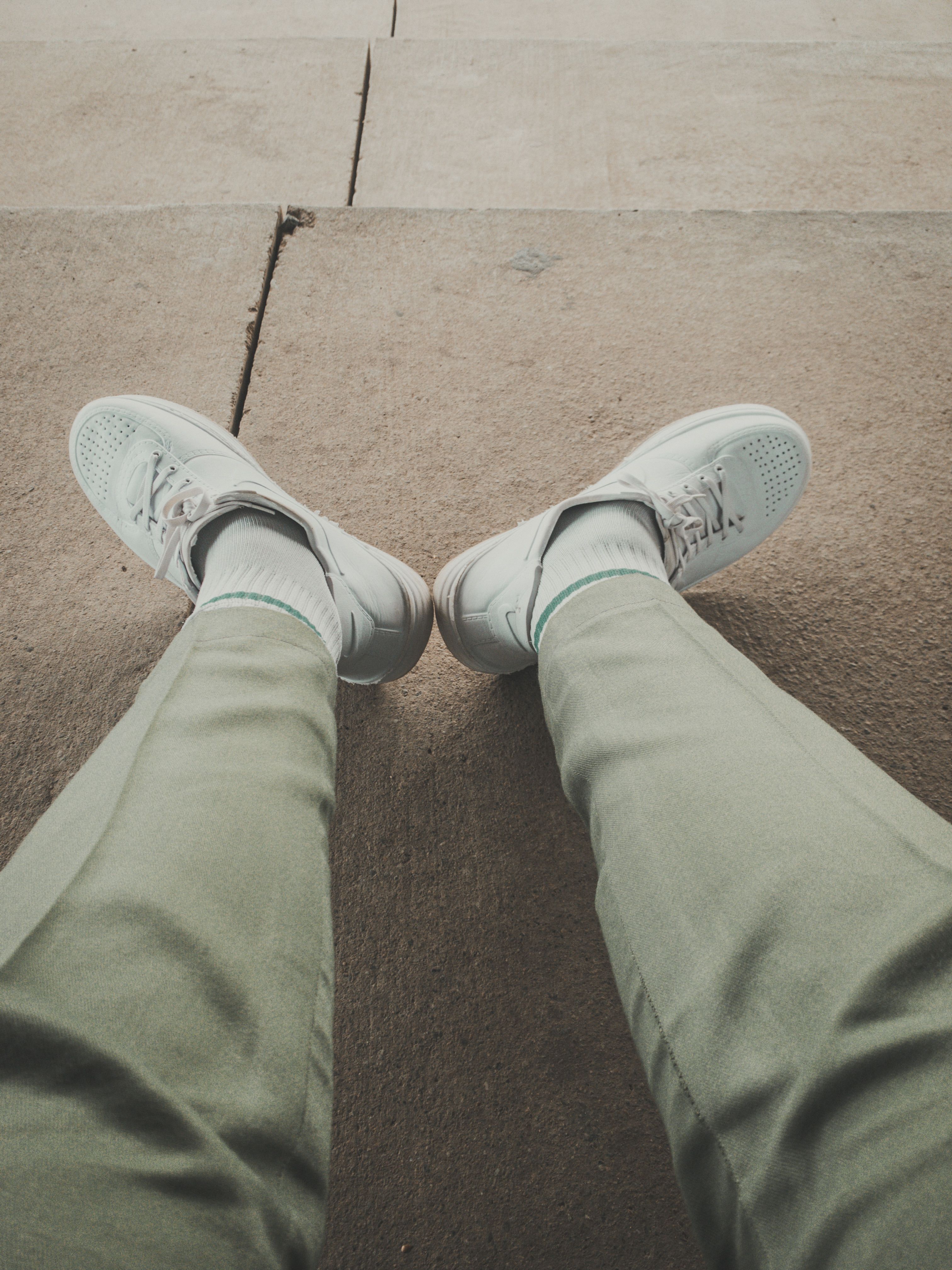 Close-Up Shot of a Person Wearing White Shoes · Free Stock Photo