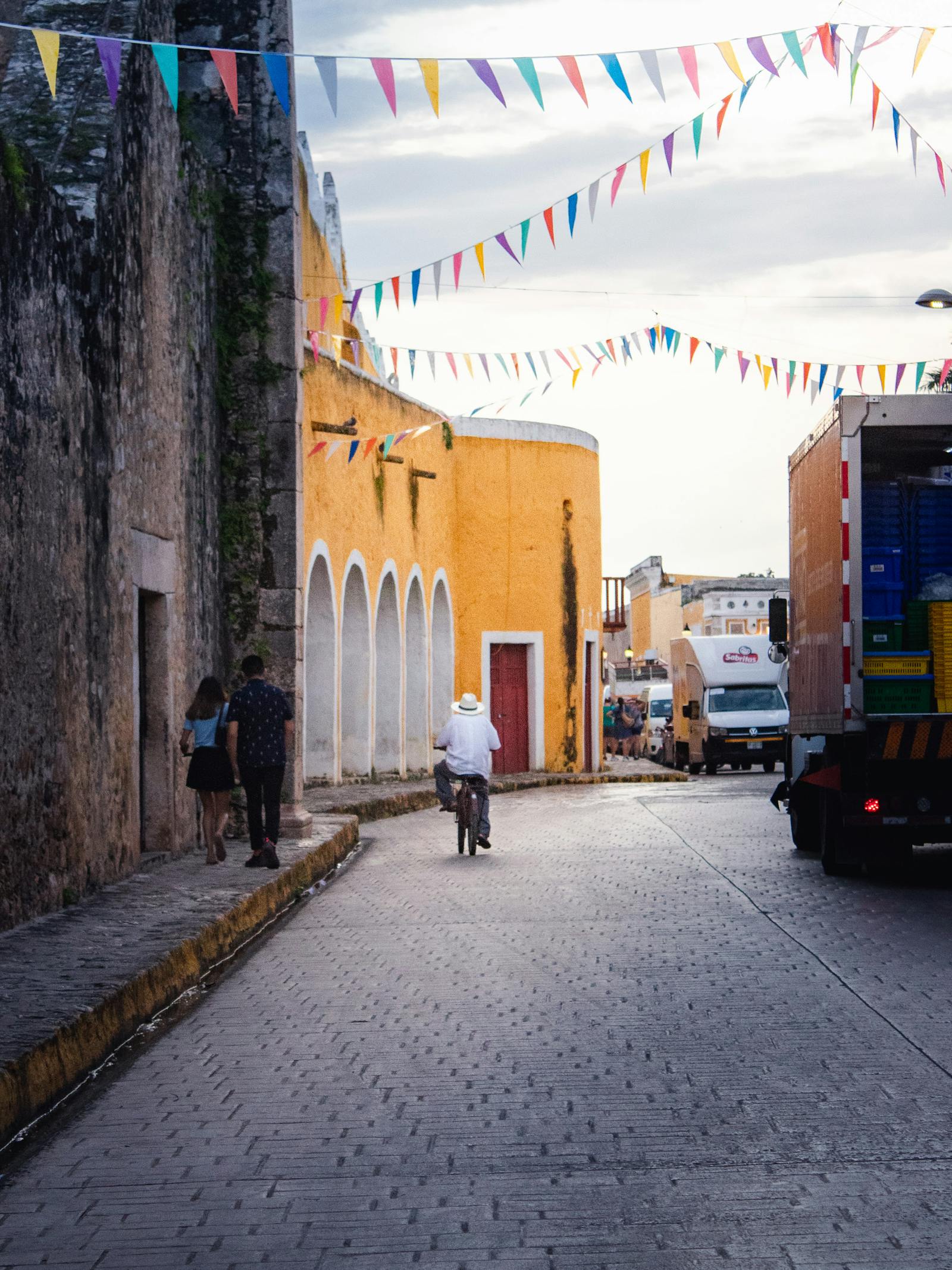 Colorful Mexican street with banderitas and people