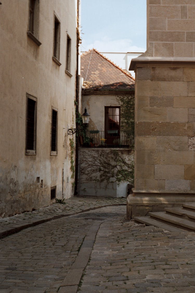 An Empty Street Between Concrete Buildings