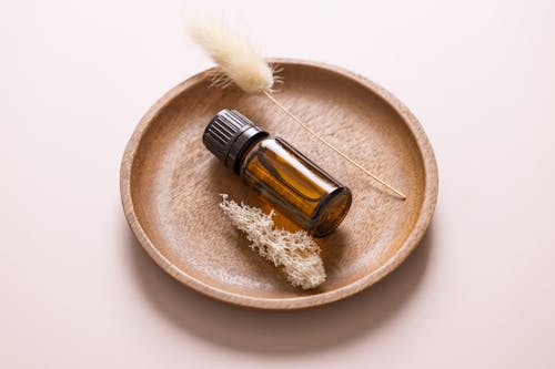 A Vial of Essential Oil on a Wooden Plate