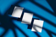 Small Paper Sheets on Blue Background