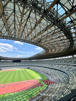 Incredible architectural design of Japan National Stadium with a clear blue sky.