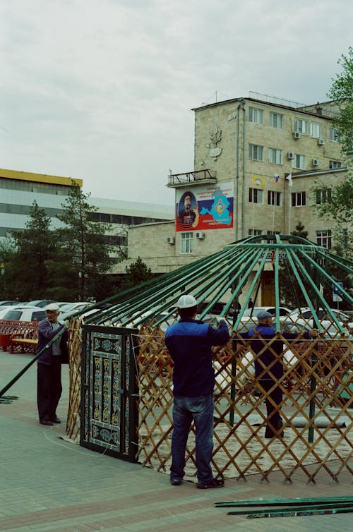 Construction Workers Setting up a Structure in the City 