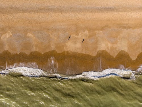 An Aerial Photography of Beach Waves Crashing on Sand