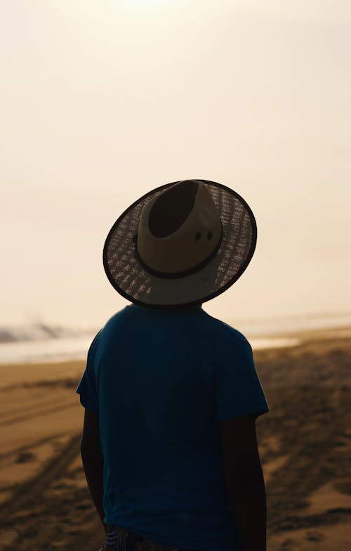 Free Person in Hat on Beach Stock Photo