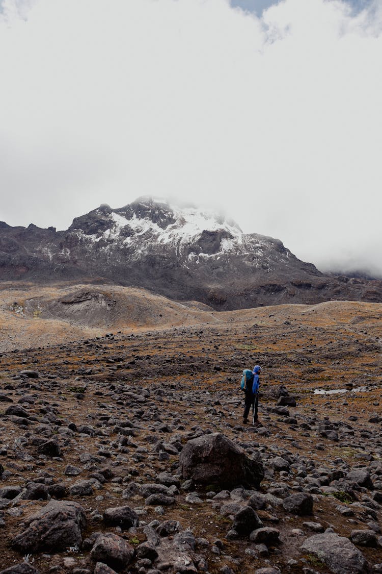 A Person With Backpack Hiking A Mountain