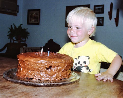 Free A Boy Celebrating His Birthday with a Chocolate Cake Stock Photo