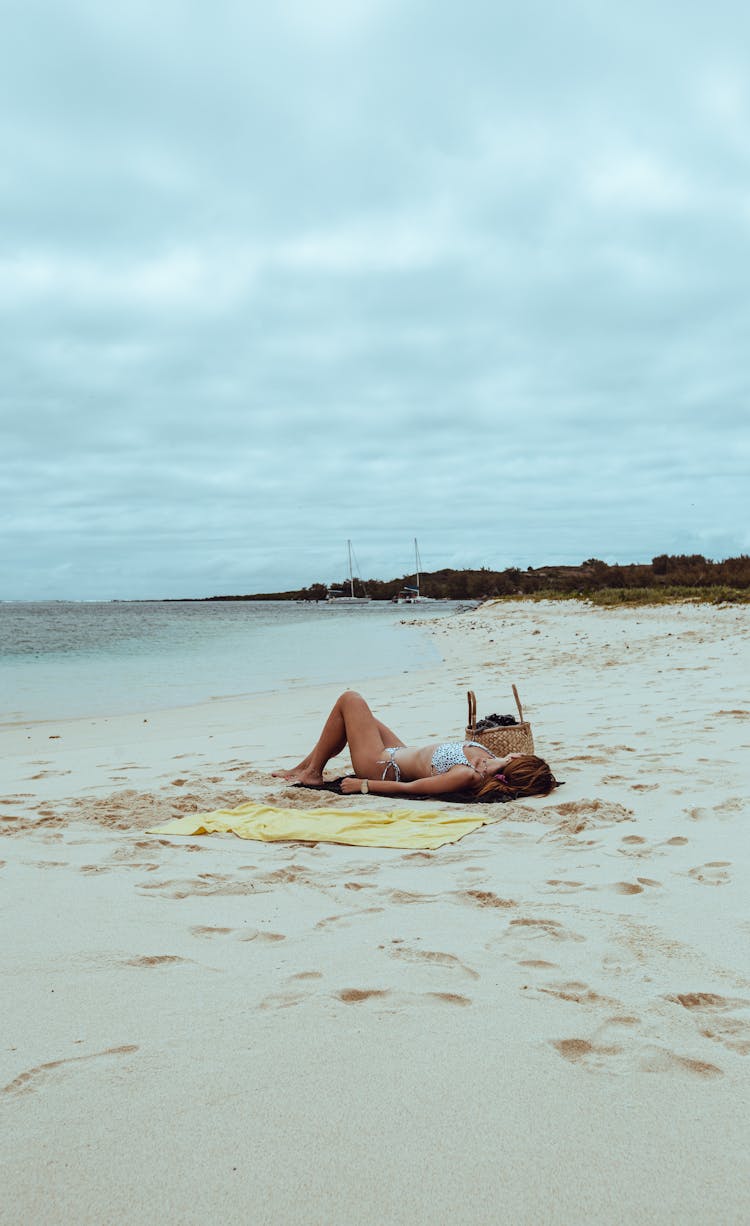 A Woman Sunbathing At The Beach 