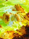 Brown and Green Rock Formation on Body of Water