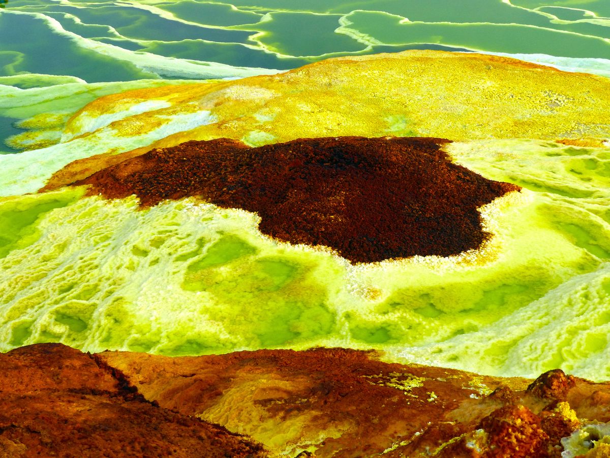 Dallol's hydrothermal field — acid-yellow and blood-red mineral deposits at the lowest, hottest point on Earth.