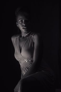 Sophisticated black and white portrait of a woman in evening wear showcasing elegant fashion