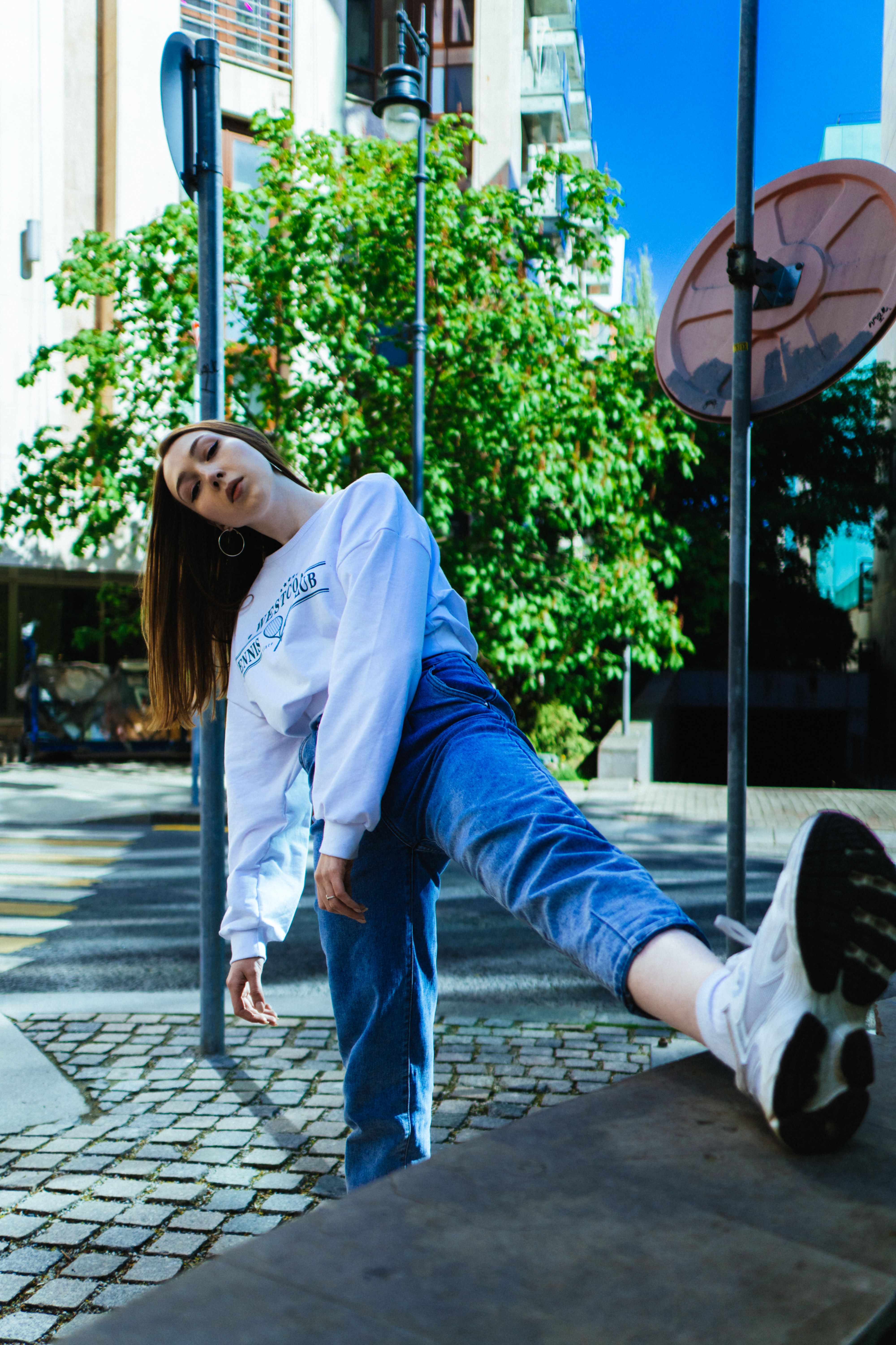 A Woman Standing on the Sidewalk · Free Stock Photo