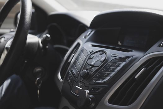 Close-up view of a modern car interior focusing on the dashboard and steering wheel.