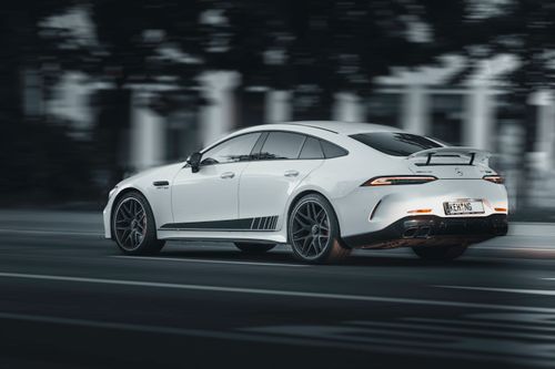 Free White luxury sports car speeding on a road, capturing motion and performance. Stock Photo